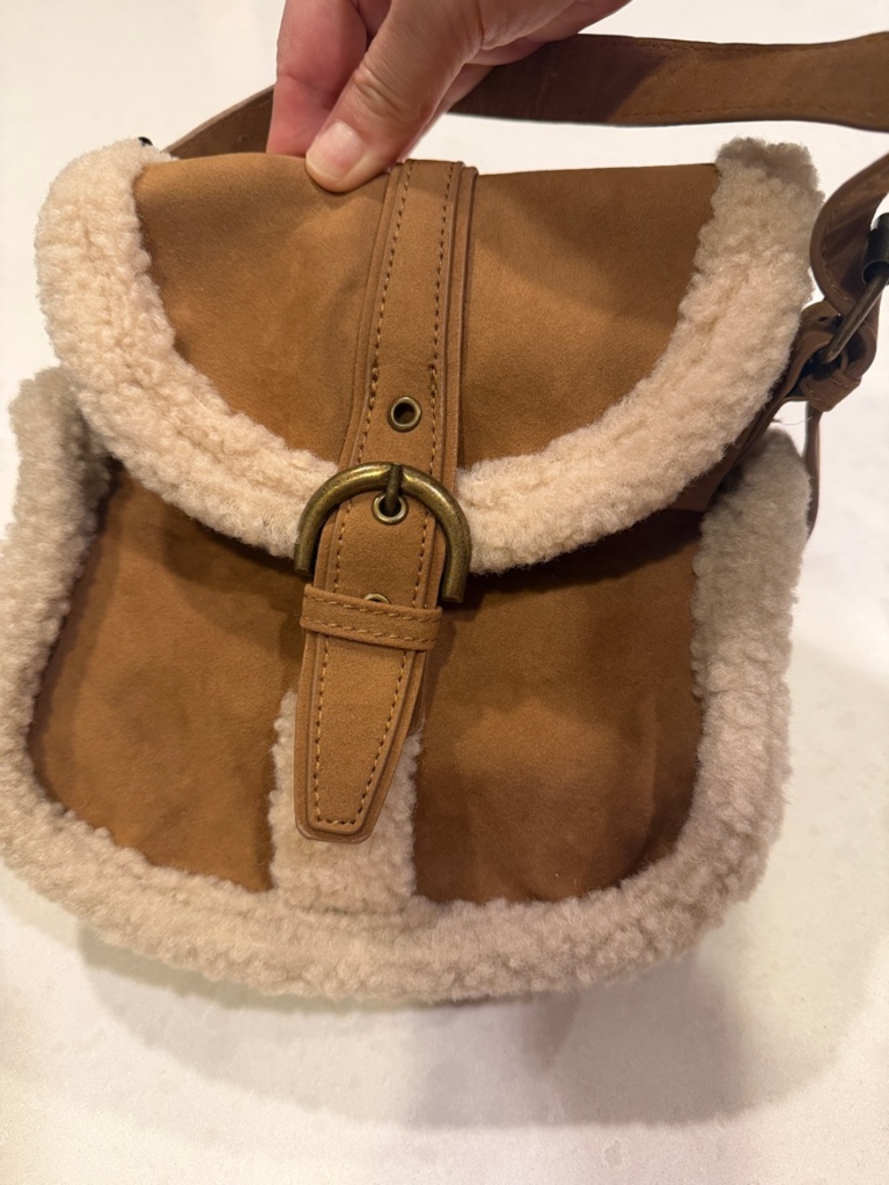 Small, cute sueded crossbody bag.